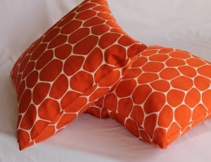 2 orange and white throw pillows thumbnail