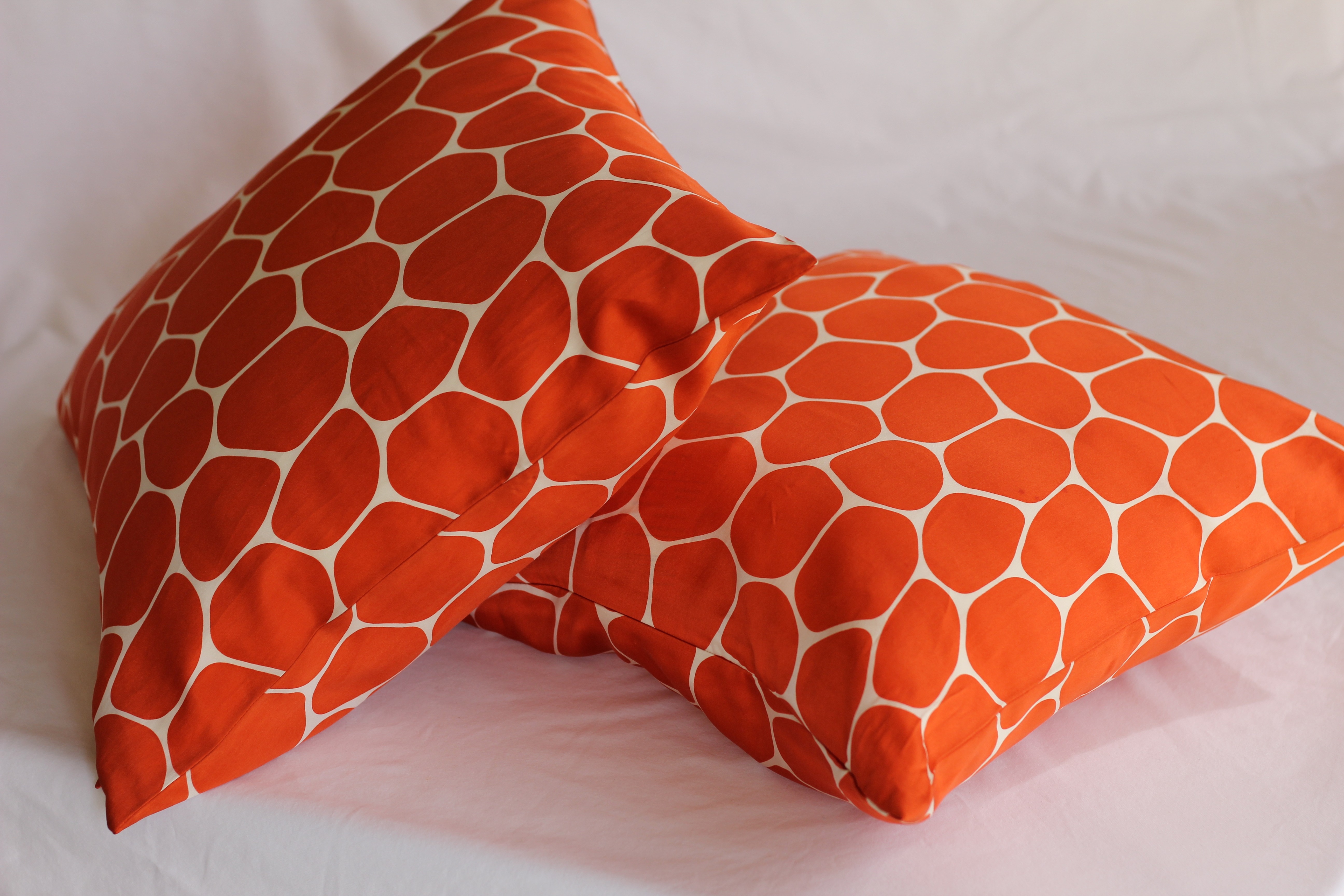 2 orange and white throw pillows