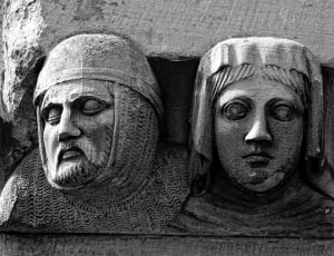 grey concrete high relief of man's and woman's face artwork thumbnail