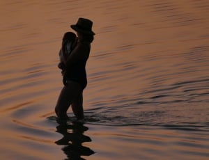 woman carrying her baby at the lake thumbnail