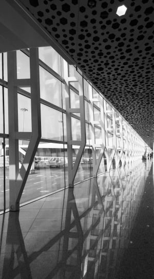 grey scale photography of interior building ceiling and clear glass walls thumbnail