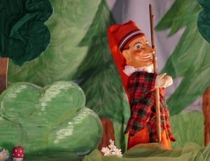 man wearing red hat figurine thumbnail