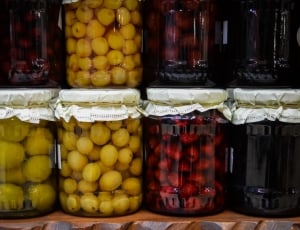 assorted round fruits on jars thumbnail