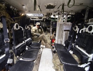 soldier sitting inside vehicle with his left hand on his cheek thumbnail