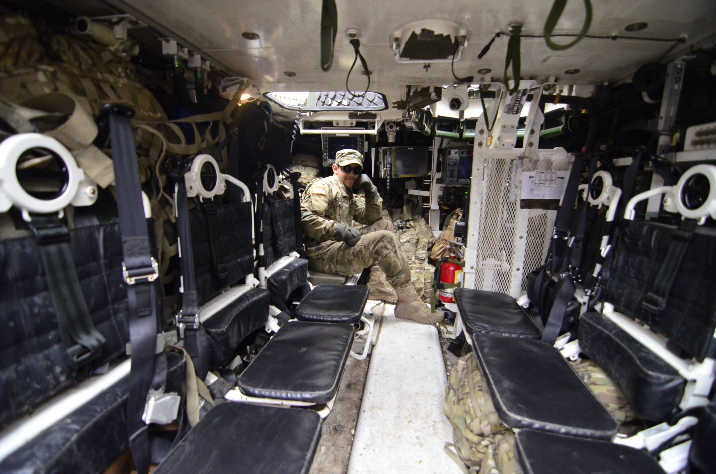 soldier sitting inside vehicle with his left hand on his cheek