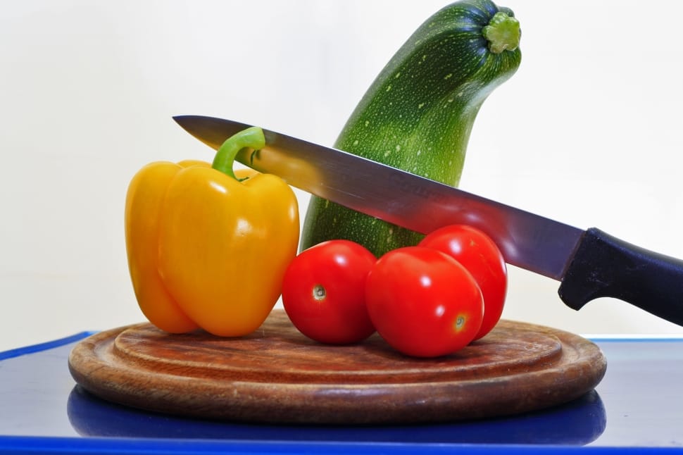 red tomatoes yellow bell pepper and kitchen knife preview