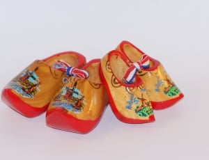 two pair of red-and-brown wooden shoes thumbnail