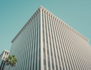 white mid-rise building in low angle photography thumbnail
