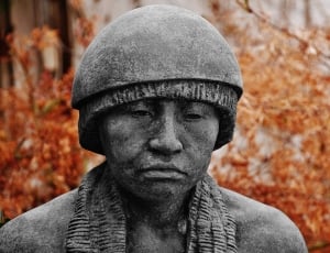 man wearing scarf and hat statue thumbnail
