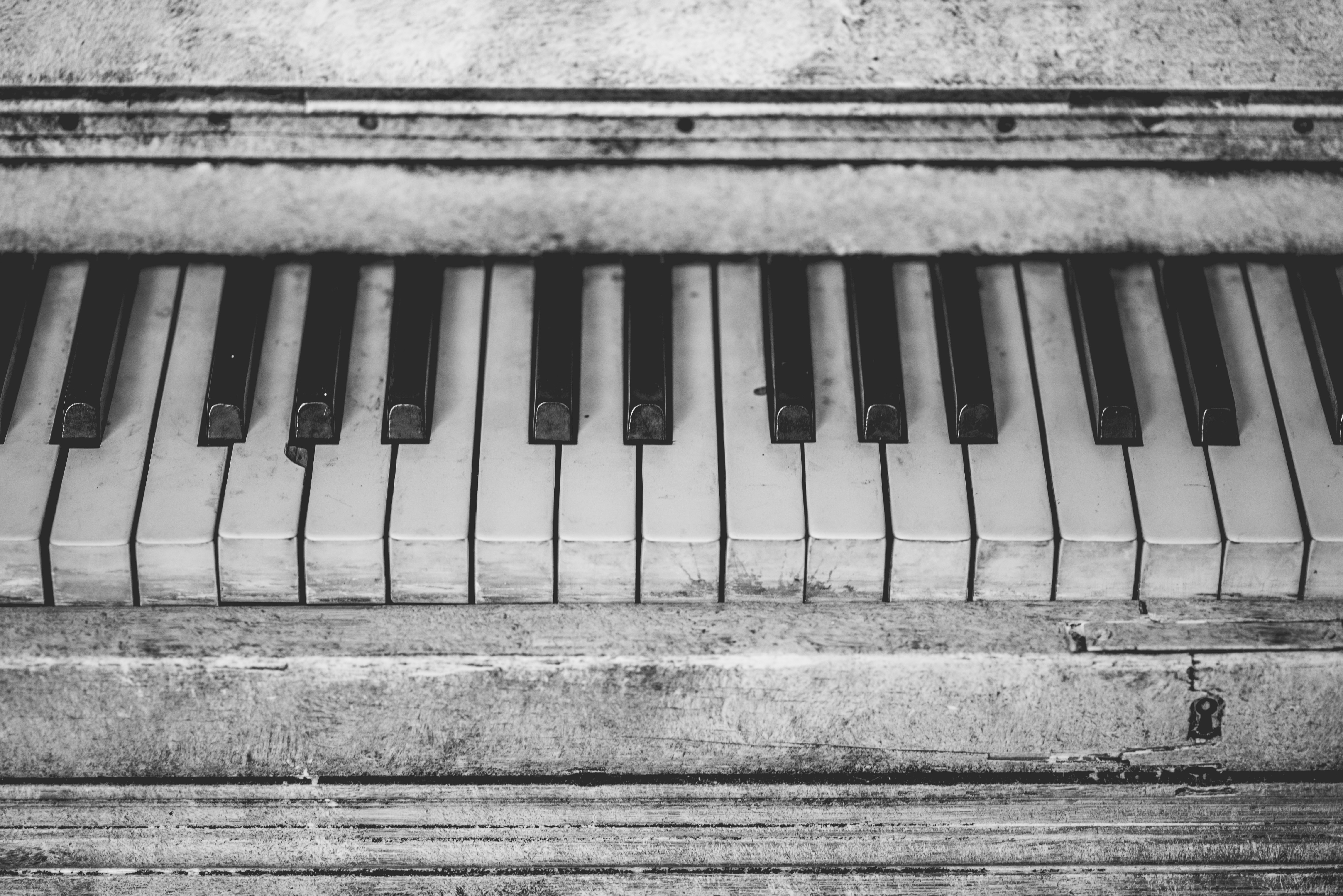 grayscale photo of piano keyboard