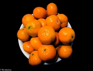 Clementines on disk in black background thumbnail