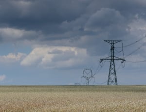 black antenna tower on the middle of wheat field thumbnail