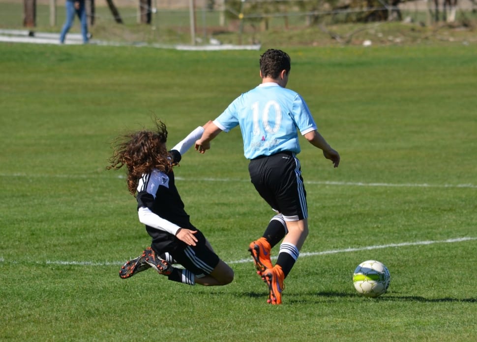 two man playing soccer on soccer field during daytime preview