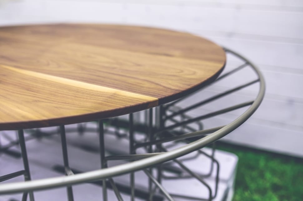 close-up of stainless steel frame brown wooden round table preview