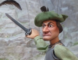 man in green hat holding sword puppet thumbnail