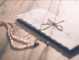 beige beaded necklace and white card thumbnail