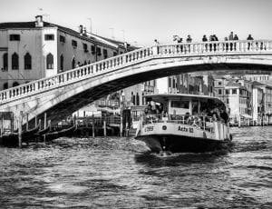ferry under bridge grayscale photo thumbnail