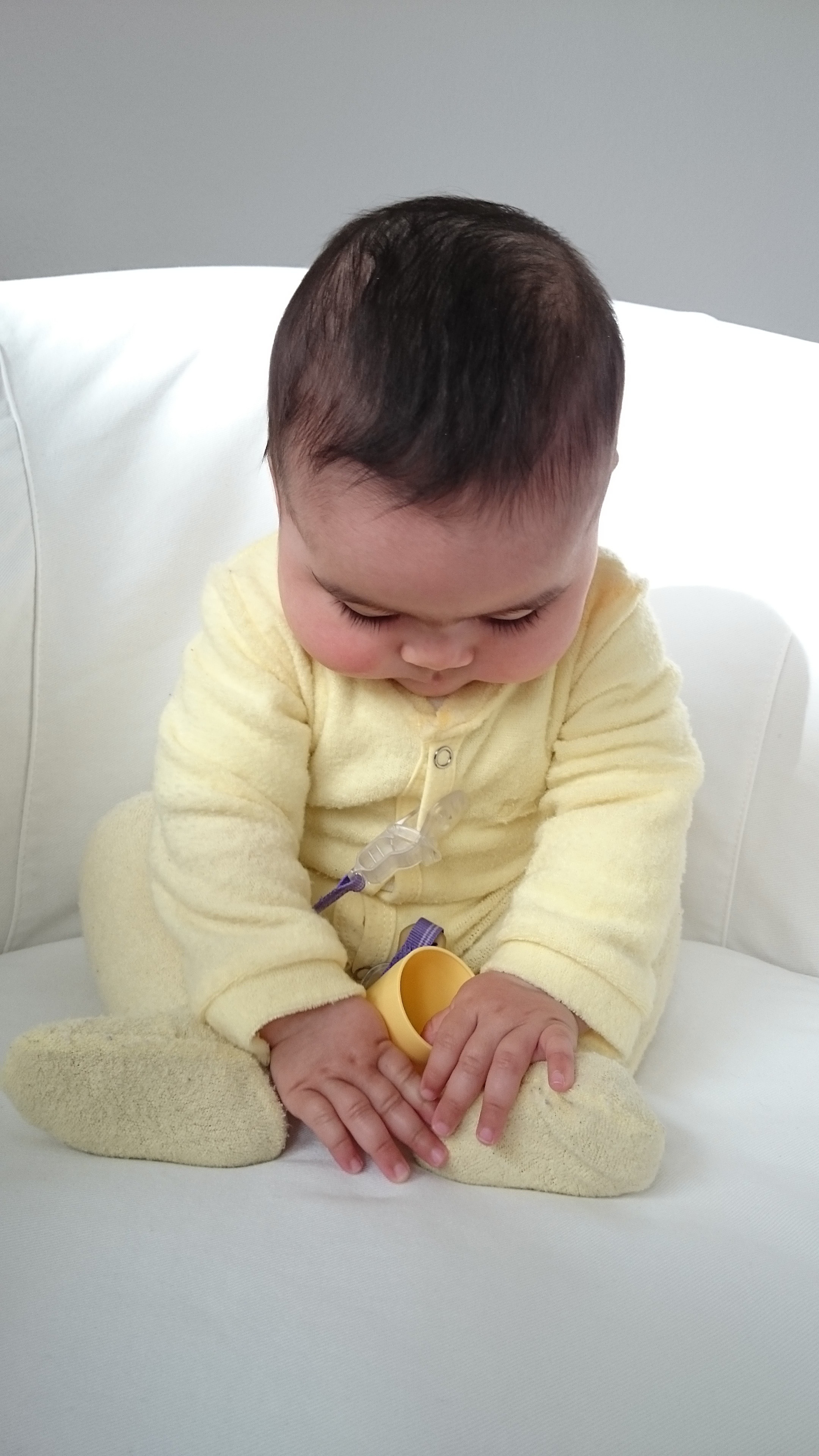 baby's yellow sleep suit