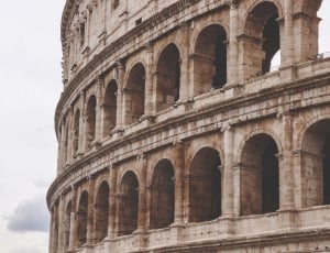 the colosseum under white clouds at daytime thumbnail