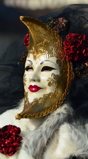 person wearing white and gold floral volto mask thumbnail