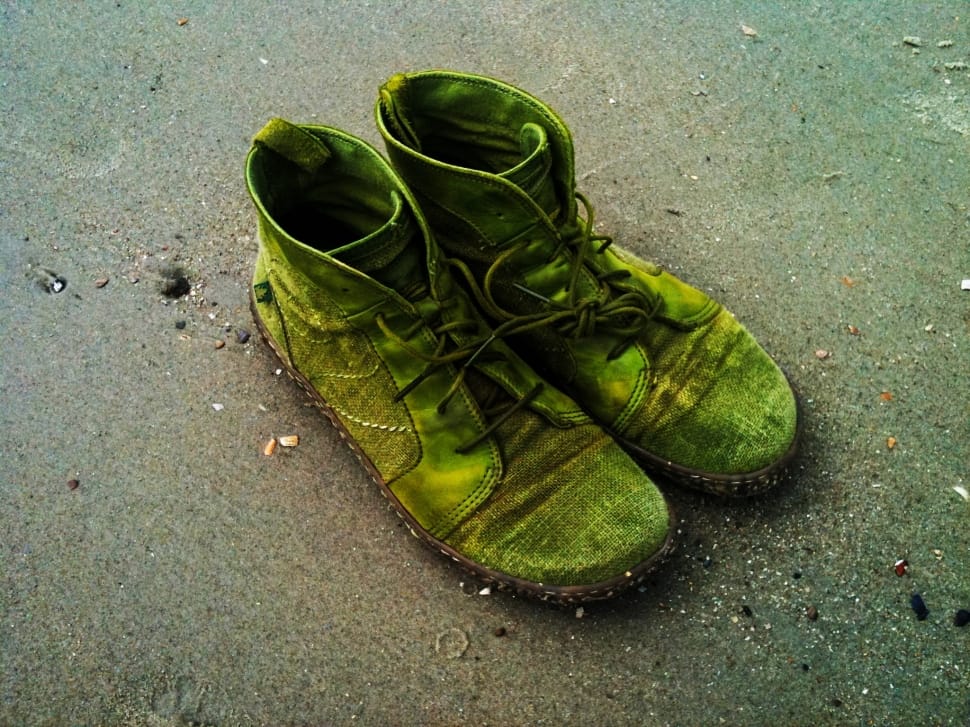 close up photography of a green high top sneakers on a beach sand preview