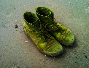 close up photography of a green high top sneakers on a beach sand thumbnail