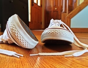 white low top sneakers on parquet floor thumbnail