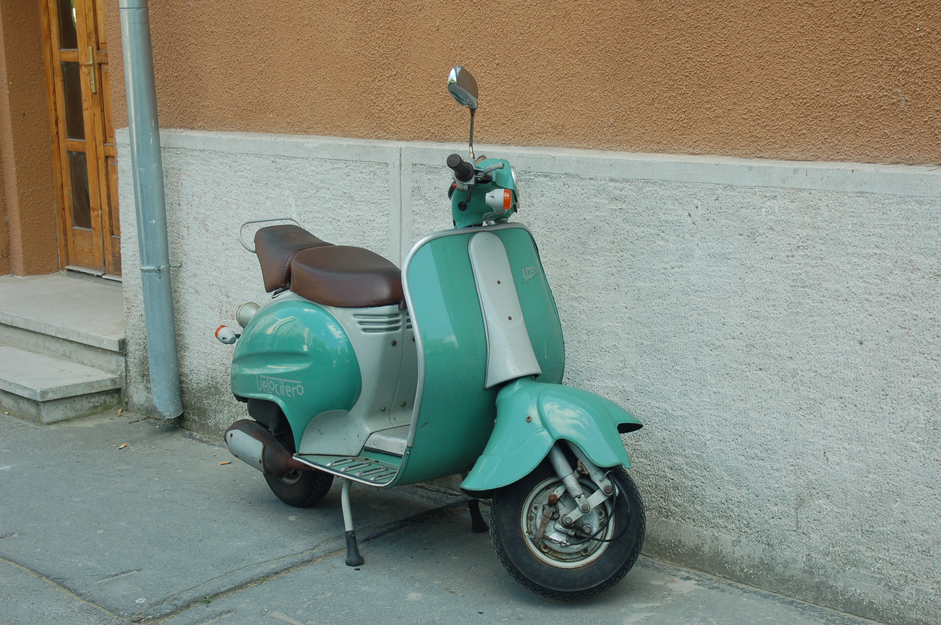 teal and white moped scooter