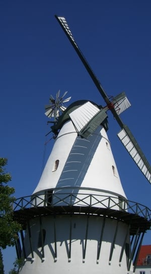 white and green windmill under blue sky thumbnail