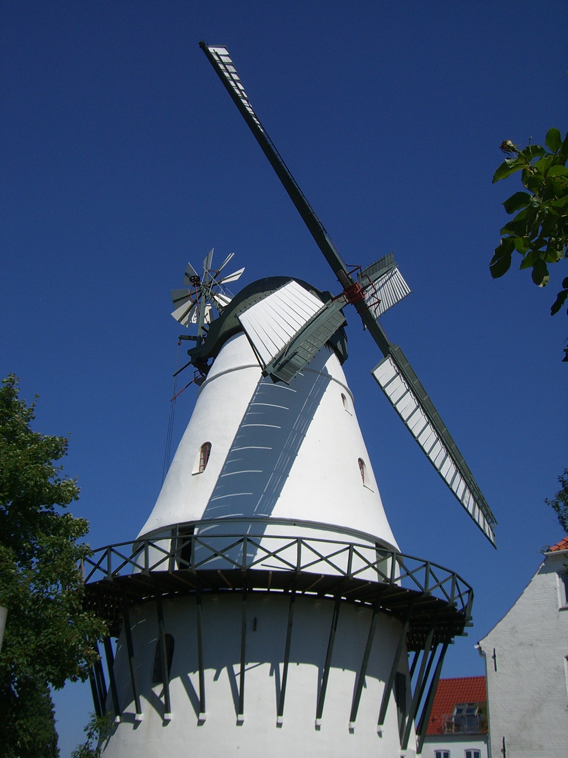 white and green windmill under blue sky