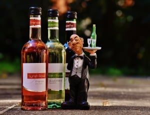 3 glass bottles with waiter figurine thumbnail