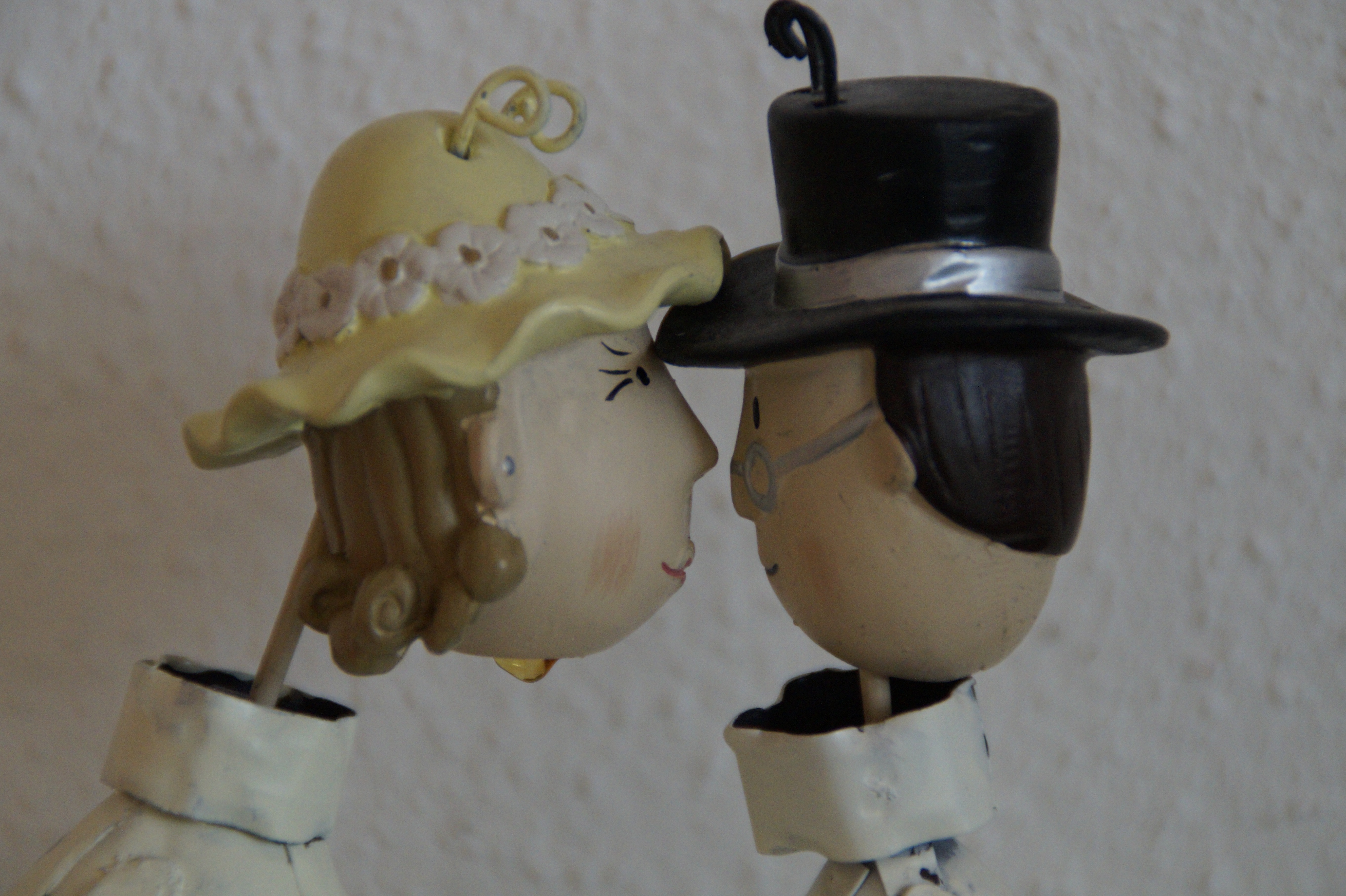 woman in white dress and man in white shirt figurine