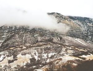 aerial photography of mountain under nimbus clouds during daytime thumbnail