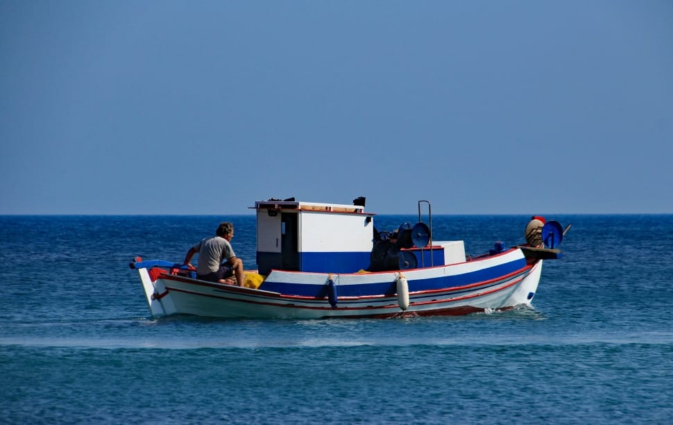 white blue and red small fishing boat preview