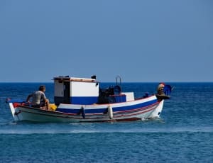white blue and red small fishing boat thumbnail