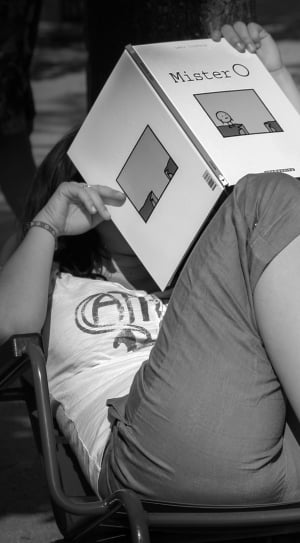 woman reading mister o book grayscale photo thumbnail