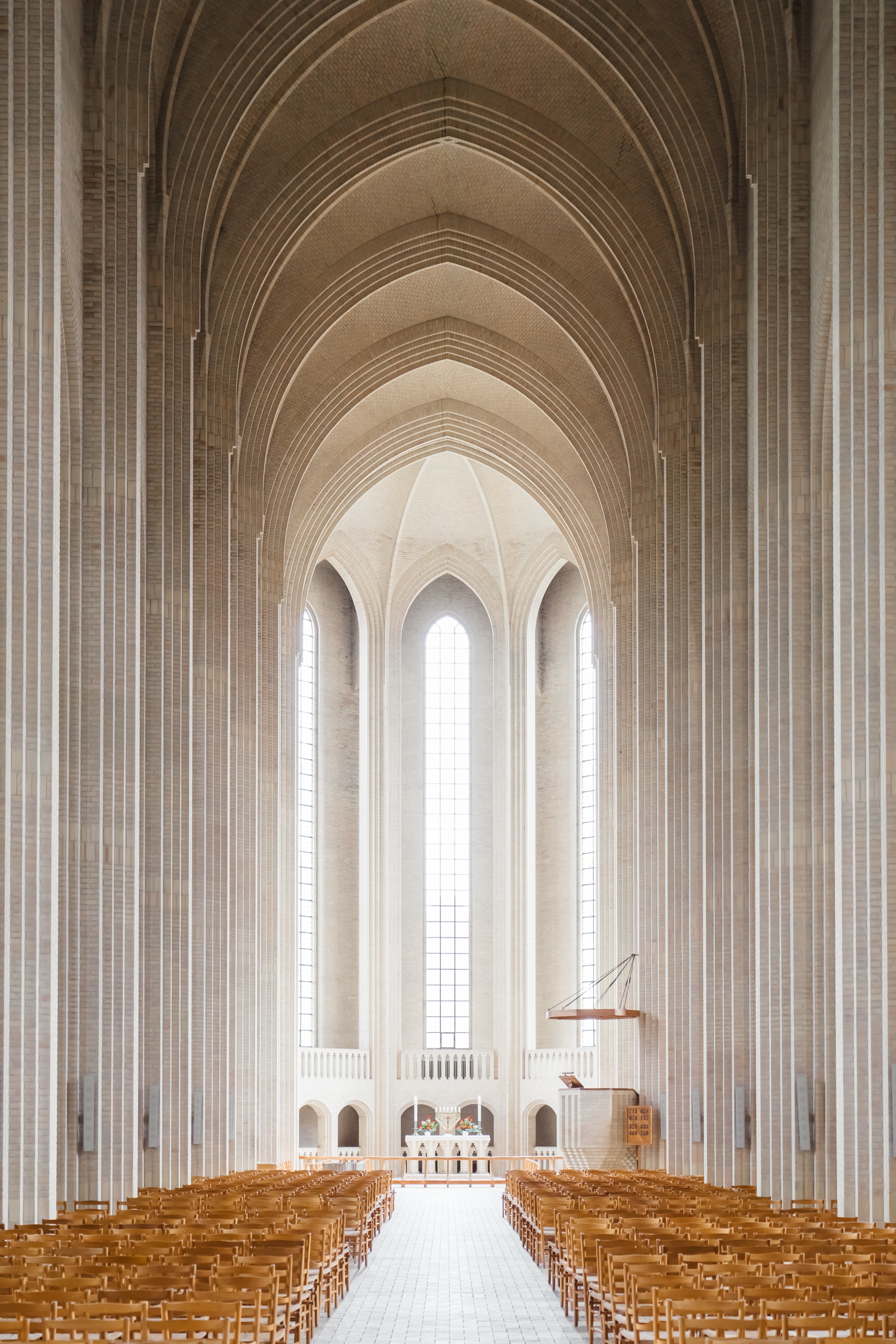 white concrete church with brown wooden chairs lot
