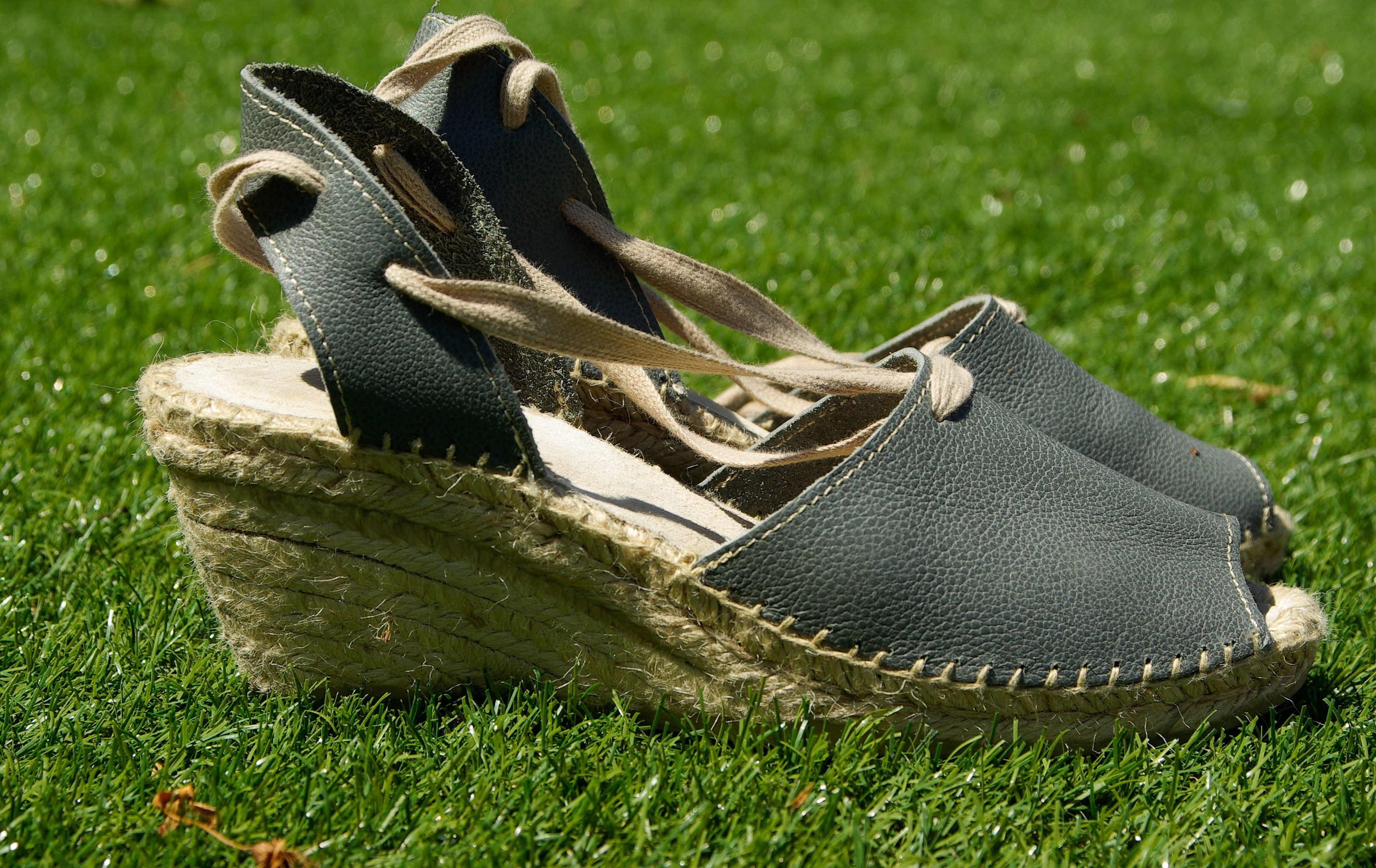 pair of espadrille wedge sandals on turf