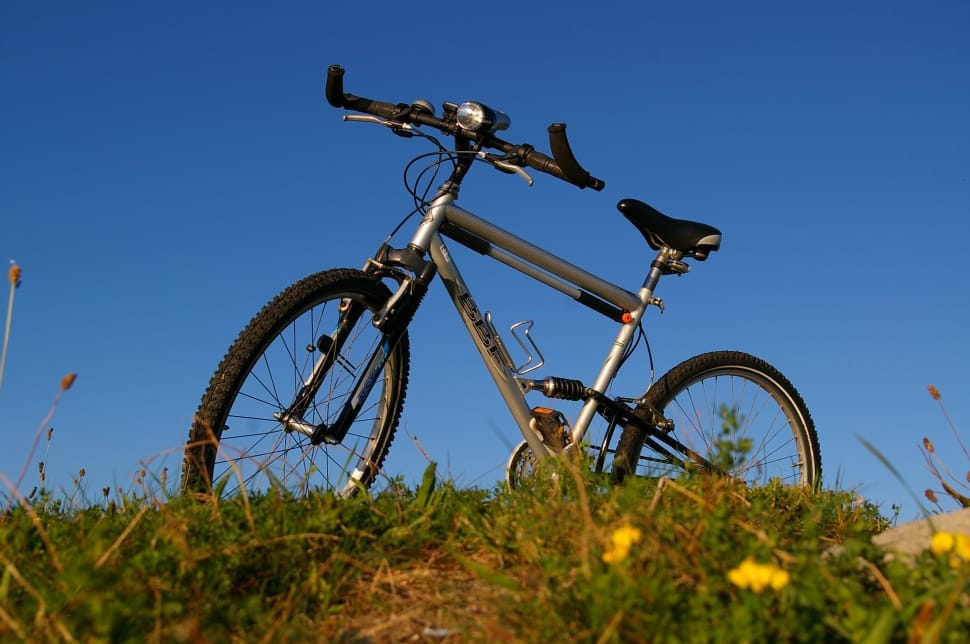 gray full suspension mountain bike parked under blue sky during daytime preview