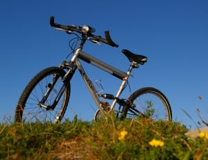 gray full suspension mountain bike parked under blue sky during daytime thumbnail