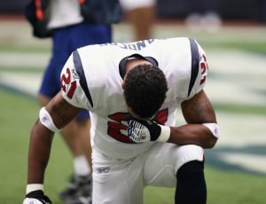 american football player in white and red jersey kneeling thumbnail
