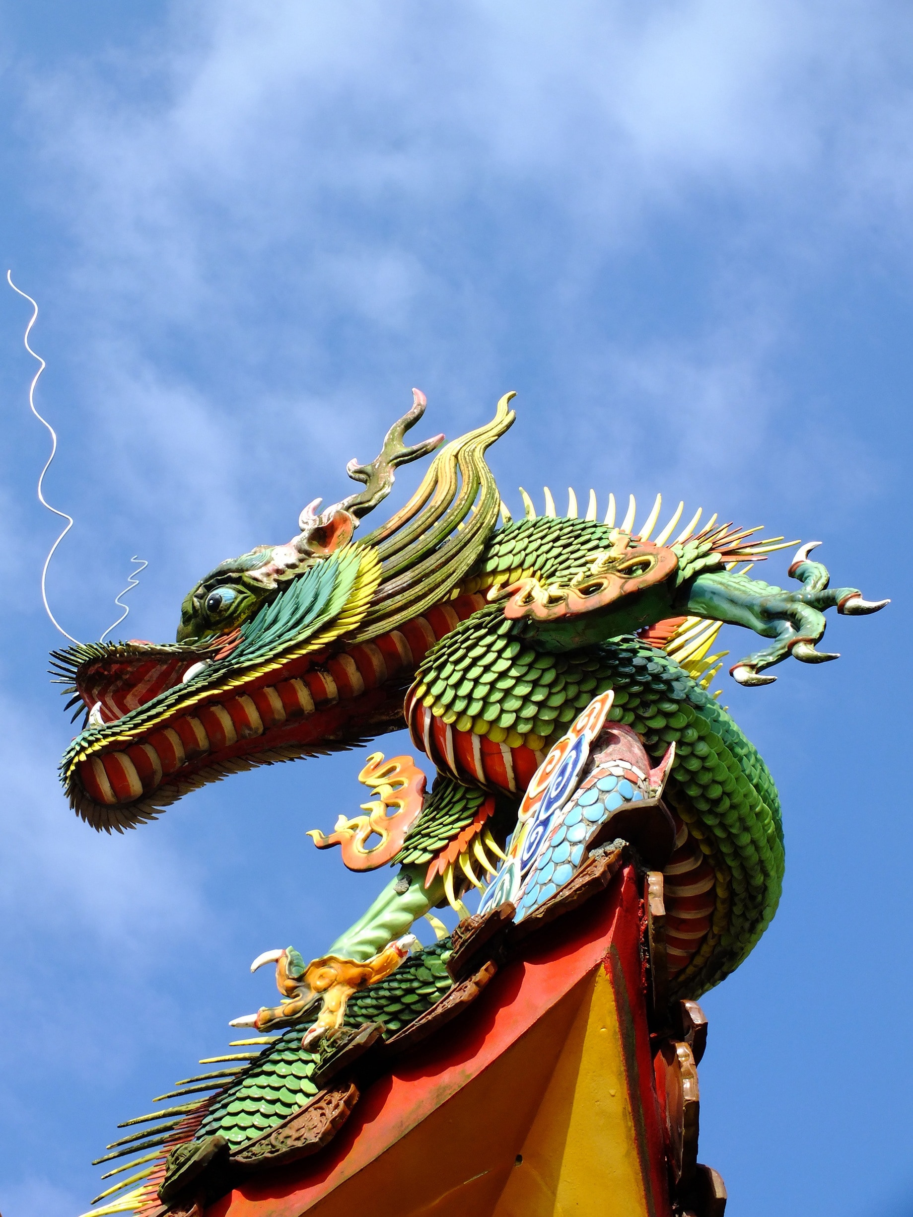 green orange and red dragon sculpture