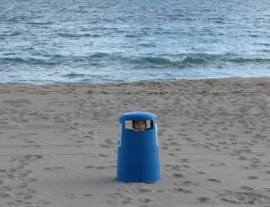 boy inside blue cylindrical container thumbnail