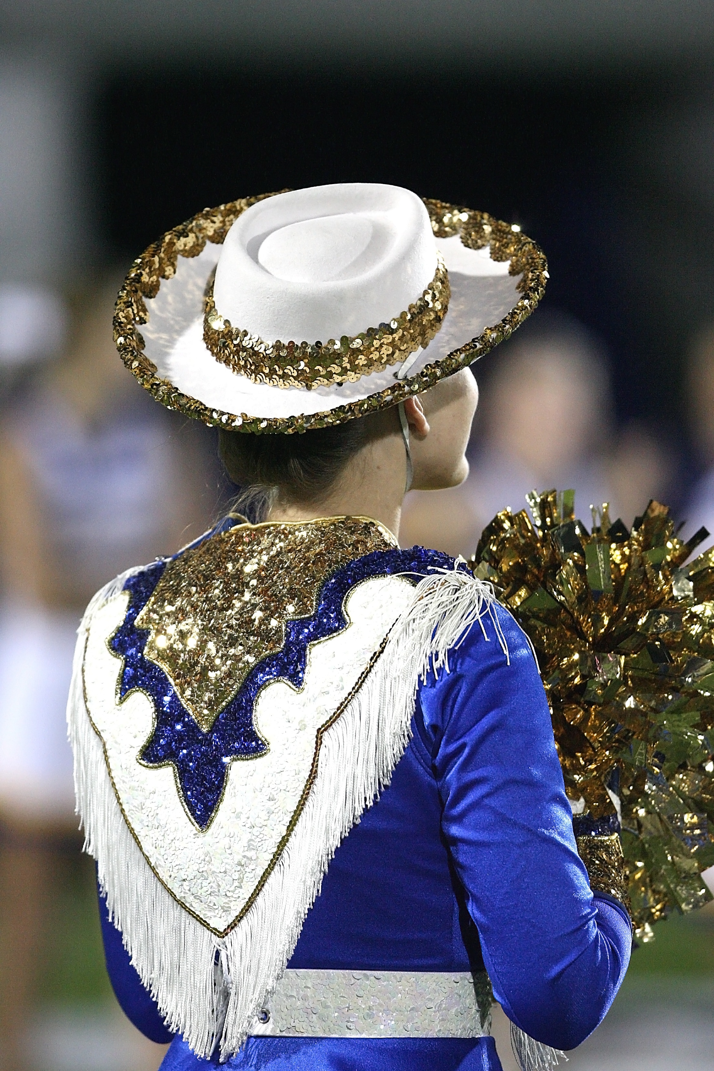 women's white and gold hat and blue and white dress uniform