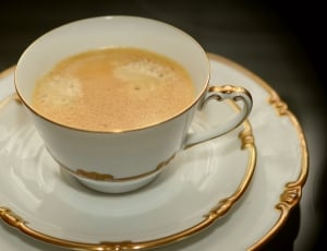 white ceramic and gold rim teacup thumbnail