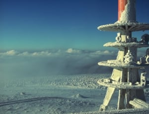 white metal tower at snow field during daytime thumbnail