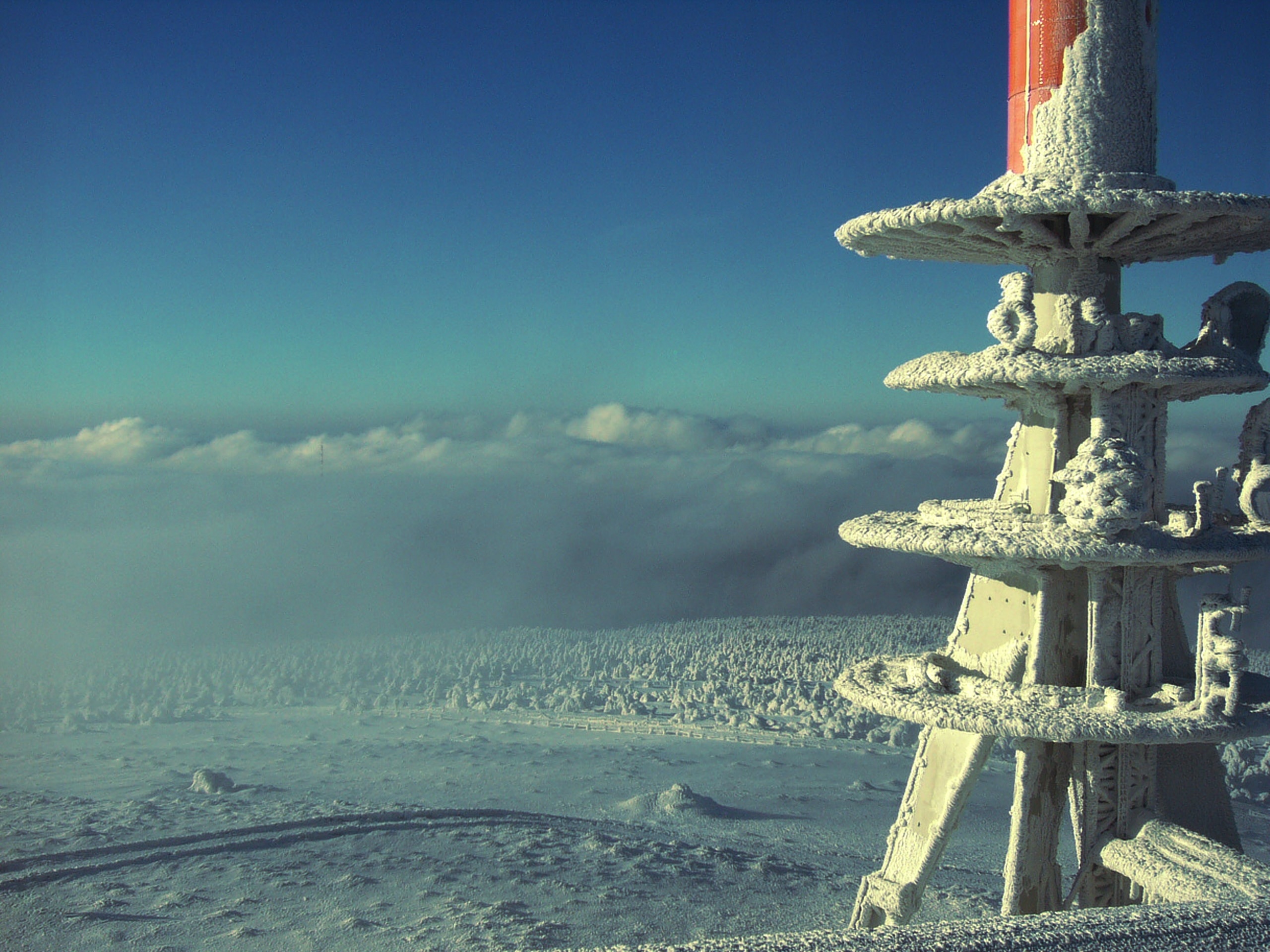 white metal tower at snow field during daytime
