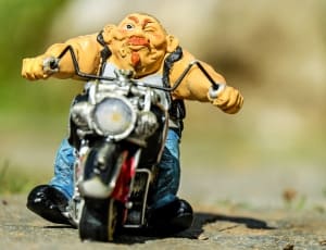 man riding motorcycle figurine thumbnail