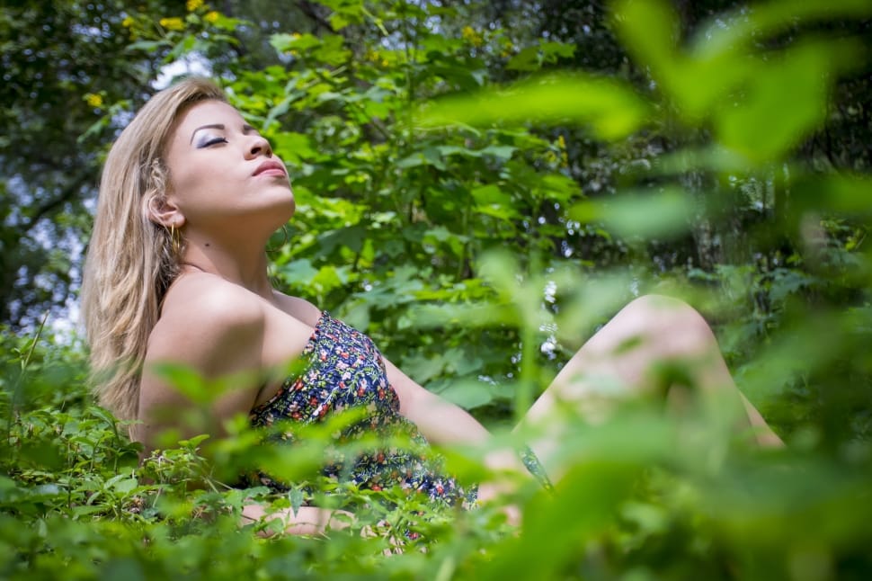 woman wearing tube dress lying on grassy ground outdoor preview
