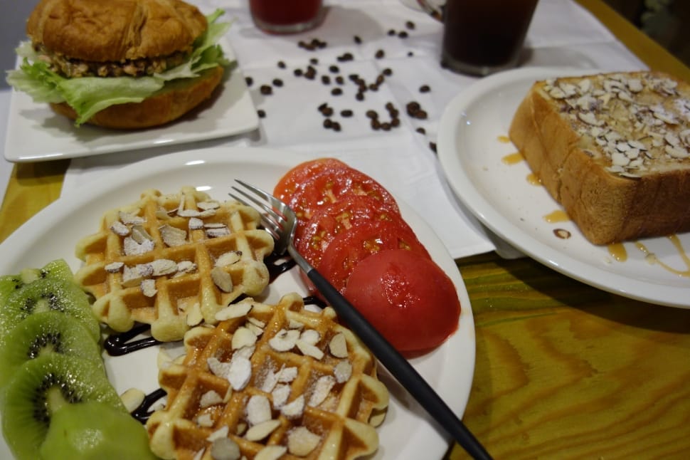 waffle tomatoes on white ceramic round plate and black and stainless steel fork preview